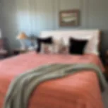 pink-green-lumbar-pillow-on-bed.jpg