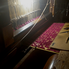 Red-fabric-on-loom-2.png