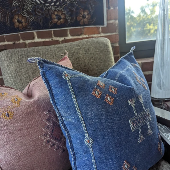 Close-up of Salwa Moroccan cactus silk throw pillow in blue with intricate geometric embroidery, styled with the pink Amina p