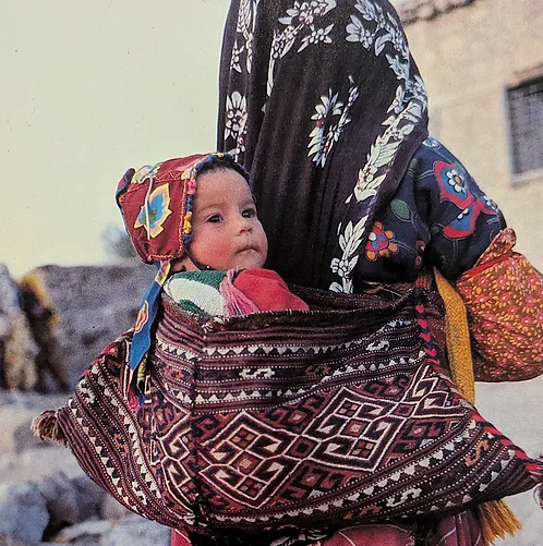 Turkish-Child-carried-by-mother.jpg