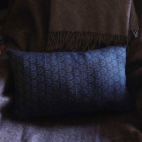 close up image of blue lumbar throw pillow woven in france