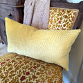 yellow lumbar pillow cushion made in italy with contemporary geometric square designs on vintage chair in living room